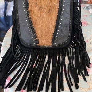 Genuine leather small cross body hair on hide.